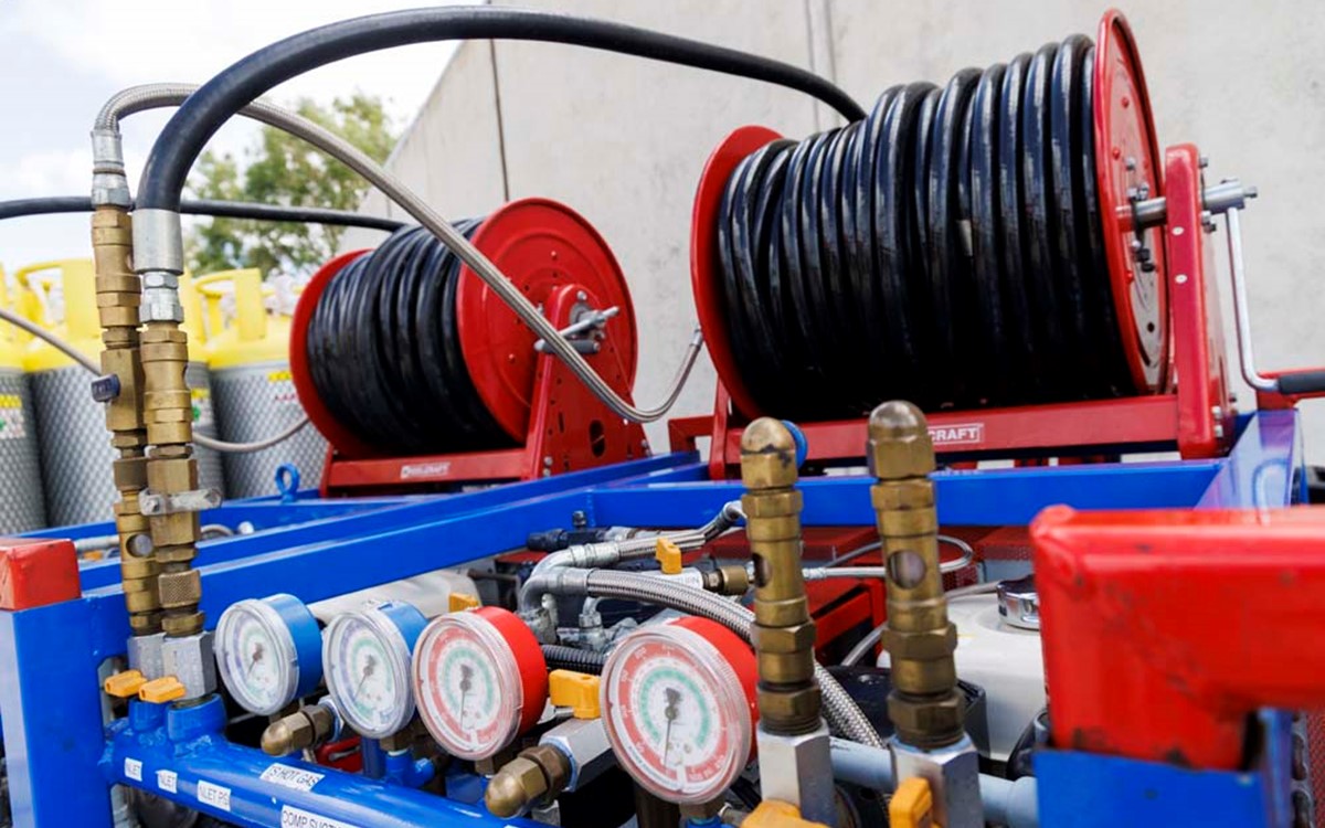 Rolls of black wire on top of blue recovery equipment