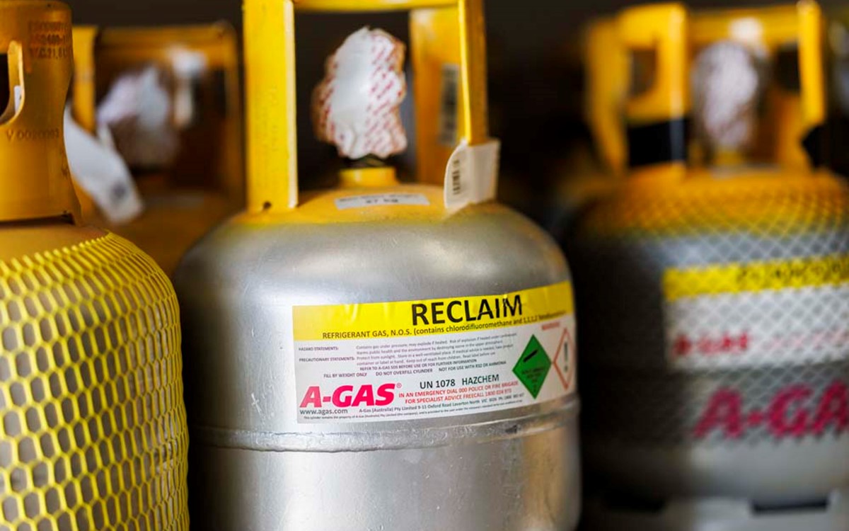 Close up of yellow and silver gas cylinder with Reclaim label
