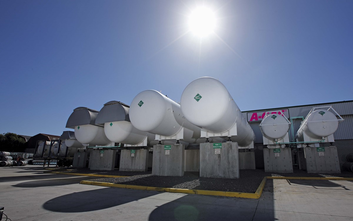 Four industrial cylinders holding gas