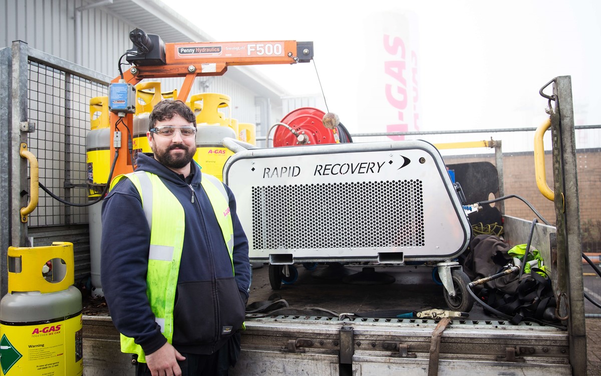 rapid recovery engineer standing with recovery vehicle