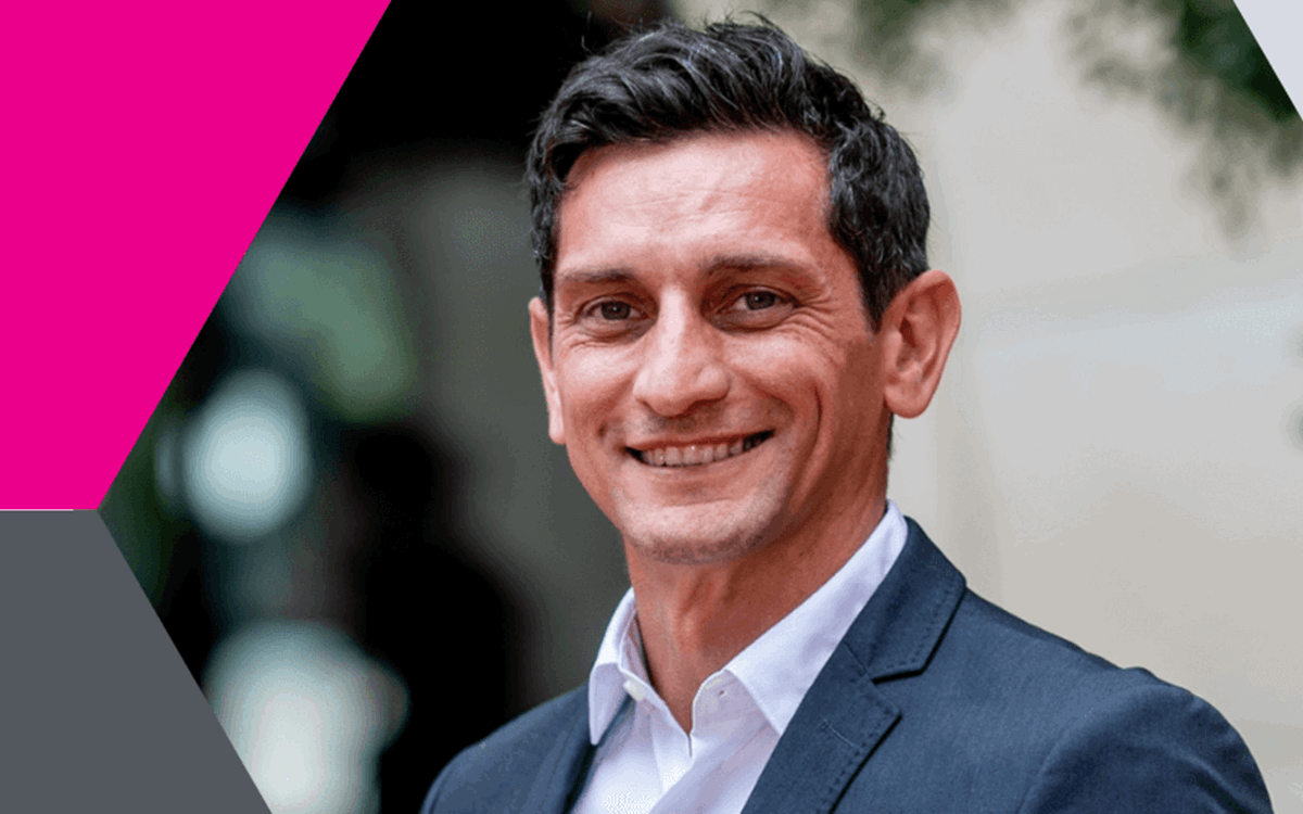 Graphic with photo of man smiling at the camera in hexagon shape