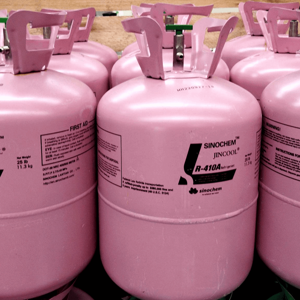 Rows of pink disposable cylinders in a warehouse 