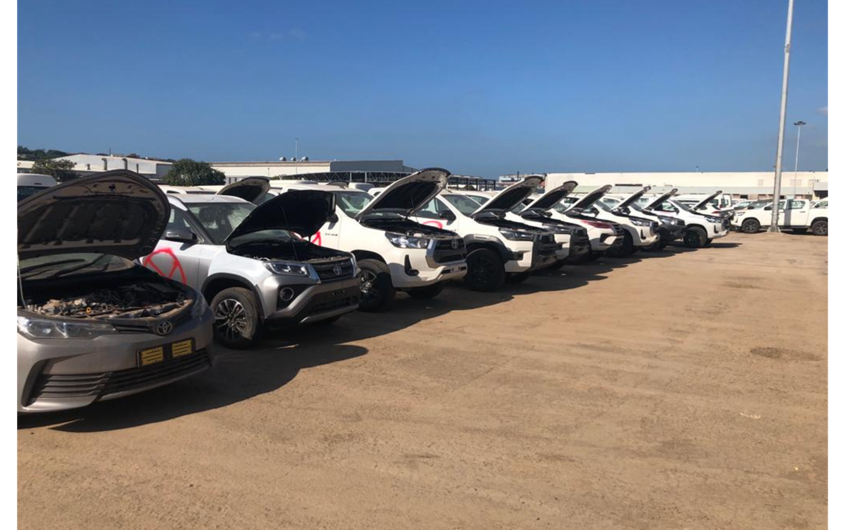 A row of cars with their bonnets open 