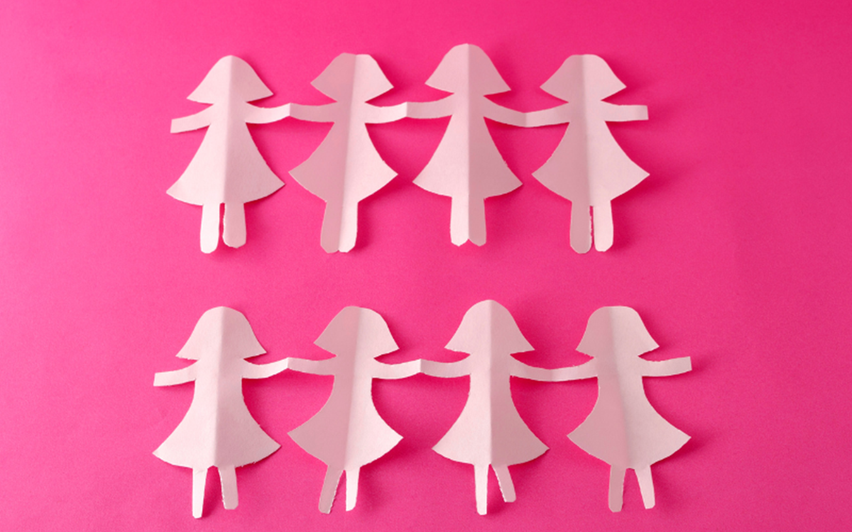 Light pink cut-outs of women against a darker pink background 